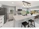 Kitchen with white cabinets, island with seating, stainless steel appliances and marble flooring at 36905 Kay Ave, Zephyrhills, FL 33542