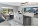 Bright kitchen featuring marble floors, stainless steel dishwasher, and an eat-in dining space at 36905 Kay Ave, Zephyrhills, FL 33542