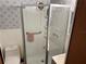 The bathroom features patterned wallpaper, a toilet, and a glass-enclosed shower with built-in shelves at 37402 Hammond Dr, Zephyrhills, FL 33541