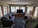 Cozy living room featuring ample natural light from surrounding windows and a comfortable seating arrangement at 37402 Hammond Dr, Zephyrhills, FL 33541
