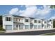 Charming townhome exterior with blue doors and shutters, offering a welcoming curb appeal at 4648 Pleasant Ave, Palm Harbor, FL 34683