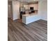 Modern kitchen featuring white cabinets, stainless steel appliances, and an island, open to the living area at 4648 Pleasant Ave, Palm Harbor, FL 34683