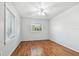 Bedroom with window, ceiling fan, hardwood floors and baseboard trim at 5101 Oakhaven Ln, Temple Terrace, FL 33617