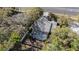 Aerial view of the backyard of a single-Gathering home showcasing a screened pool at 6009 County Line Rd, Spring Hill, FL 34606