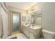 Bathroom featuring neutral tones, tile flooring, vanity, toilet and large mirror at 6009 County Line Rd, Spring Hill, FL 34606