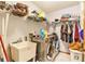Laundry room with washer, dryer, storage shelves, and a utility sink at 6009 County Line Rd, Spring Hill, FL 34606