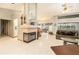 Spacious living room with a fireplace, tile floors, and a large window overlooking the pool area at 6009 County Line Rd, Spring Hill, FL 34606