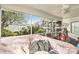 View of the in-ground spa from inside the screen-enclosed patio at 6009 County Line Rd, Spring Hill, FL 34606