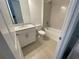 Bathroom with a shower-tub combo, white vanity, and neutral finishes creating a serene space at 6212 Broad Field Ave, Apollo Beach, FL 33572