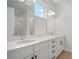 Bathroom featuring double sinks, modern vanity, quartz countertops, and a well-lit mirror at 6212 Broad Field Ave, Apollo Beach, FL 33572