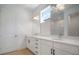 Bathroom featuring double sinks, modern vanity, quartz countertops, and a well-lit mirror at 6212 Broad Field Ave, Apollo Beach, FL 33572