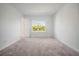 Spacious bedroom featuring plush carpeting, a window with natural light, and neutral wall paint at 6212 Broad Field Ave, Apollo Beach, FL 33572