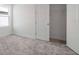 Bright bedroom with neutral carpet, white walls, and ample closet space creating a serene and organized atmosphere at 6212 Broad Field Ave, Apollo Beach, FL 33572