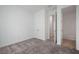 Inviting bedroom featuring plush neutral carpet, white walls, double closet, and adjacent room providing options at 6212 Broad Field Ave, Apollo Beach, FL 33572