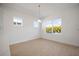 Bright dining area illuminated by a modern pendant light and large windows at 6212 Broad Field Ave, Apollo Beach, FL 33572