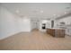 Spacious living room leading into kitchen with a large center island and ample cabinet space at 6212 Broad Field Ave, Apollo Beach, FL 33572