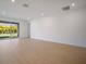 Bright living room featuring hardwood floors and sliding glass doors to the outdoor living space at 6212 Broad Field Ave, Apollo Beach, FL 33572