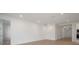 Open-concept living area with bright white walls and sleek hardwood flooring at 6212 Broad Field Ave, Apollo Beach, FL 33572