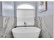 Bright bathroom featuring a modern soaking tub and marble accent wall at 6224 Vista Verde W Dr, St Petersburg, FL 33707