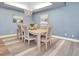 Formal dining room with decorative chandelier, rug, and beach themed artwork at 6224 Vista Verde W Dr, St Petersburg, FL 33707
