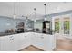 Open concept kitchen features granite countertops, white cabinetry, and pendant lighting above bar seating at 6224 Vista Verde W Dr, St Petersburg, FL 33707