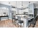 Modern kitchen with stainless steel appliances, a breakfast bar with seating, white cabinets and black countertops at 6224 Vista Verde W Dr, St Petersburg, FL 33707