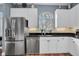 Bright kitchen features stainless steel appliances, granite countertops, and a window over the sink at 6224 Vista Verde W Dr, St Petersburg, FL 33707