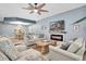 Cozy living room with an adjacent dining area, fireplace, ceiling fan, and neutral furniture and decor at 6224 Vista Verde W Dr, St Petersburg, FL 33707