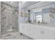 Elegant main bathroom features white marble floors, a glass shower, and double vanity sinks at 6224 Vista Verde W Dr, St Petersburg, FL 33707