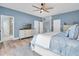 Bright main bedroom featuring a ceiling fan, luxury vinyl floors, and ensuite bathroom at 6224 Vista Verde W Dr, St Petersburg, FL 33707