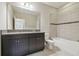 Bathroom with a granite countertop, cabinets, and tiled shower/tub combination at 10825 Charmwood Dr, Riverview, FL 33569