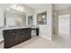 Bathroom with double granite vanity, tile floor, and seamless glass shower at 10825 Charmwood Dr, Riverview, FL 33569