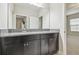 Bathroom with granite countertop vanity, cabinets, and a mirror at 10825 Charmwood Dr, Riverview, FL 33569