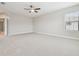 Neutral bedroom with ceiling fan, carpet, and a door frame to another room at 10825 Charmwood Dr, Riverview, FL 33569