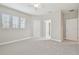 Bright bedroom with neutral paint, plush carpeting, a ceiling fan and bright windows with wood blinds at 10825 Charmwood Dr, Riverview, FL 33569
