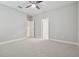 Spacious carpeted bedroom with ceiling fan, connecting doors, and neutral walls at 10825 Charmwood Dr, Riverview, FL 33569