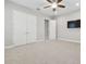 Spacious bedroom features plush carpeting, ceiling fan, and large double-door closet at 10825 Charmwood Dr, Riverview, FL 33569