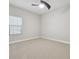 Neutral bedroom with plush carpeting, window with blinds, and white trim at 10825 Charmwood Dr, Riverview, FL 33569