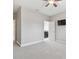 Spacious carpeted bedroom with a ceiling fan, television, and adjoining bathroom at 10825 Charmwood Dr, Riverview, FL 33569