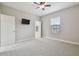 Bedroom with carpet, ceiling fan, a TV, and natural light through the window at 10825 Charmwood Dr, Riverview, FL 33569