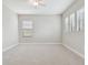 Bright bedroom with neutral tones, carpet flooring, ceiling fan, and large windows with wood blinds at 10825 Charmwood Dr, Riverview, FL 33569