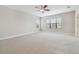 Bright bedroom featuring a ceiling fan, carpeted floor, and natural light at 10825 Charmwood Dr, Riverview, FL 33569