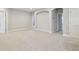 Spacious bonus room with neutral paint, carpet, and archway access at 10825 Charmwood Dr, Riverview, FL 33569