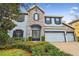 Charming two-story home featuring a stone facade, well-manicured lawn and an attached three-car garage at 10825 Charmwood Dr, Riverview, FL 33569