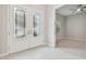 Inviting foyer featuring decorative glass front doors, tile flooring and view of a bedroom at 10825 Charmwood Dr, Riverview, FL 33569