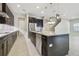 Modern kitchen with dark cabinetry, stainless steel appliances, and a spacious center island at 10825 Charmwood Dr, Riverview, FL 33569