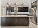 Modern kitchen with dark cabinetry, stainless steel appliances, a large island with pendant lights at 10825 Charmwood Dr, Riverview, FL 33569