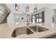 Close-up of the kitchen island featuring a stainless steel sink and modern faucet at 10825 Charmwood Dr, Riverview, FL 33569