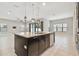 Bright, open kitchen features a large island with pendant lighting and stainless steel appliances at 10825 Charmwood Dr, Riverview, FL 33569