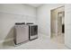 Well-organized laundry room with modern appliances, open shelf and access to the living spaces at 10825 Charmwood Dr, Riverview, FL 33569
